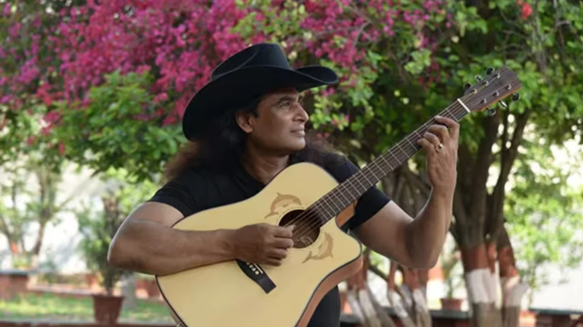 Indian country singer Bobby Cash with his guitar wearing a cowboy hat